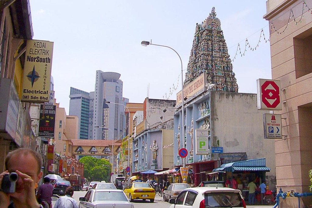 Sri Maha Mariamman's pyramid of figures is hard to miss. A videographer looks on.