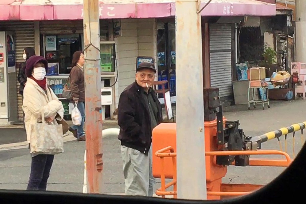 people-waiting-for-train-to-pass-hankai-sakai