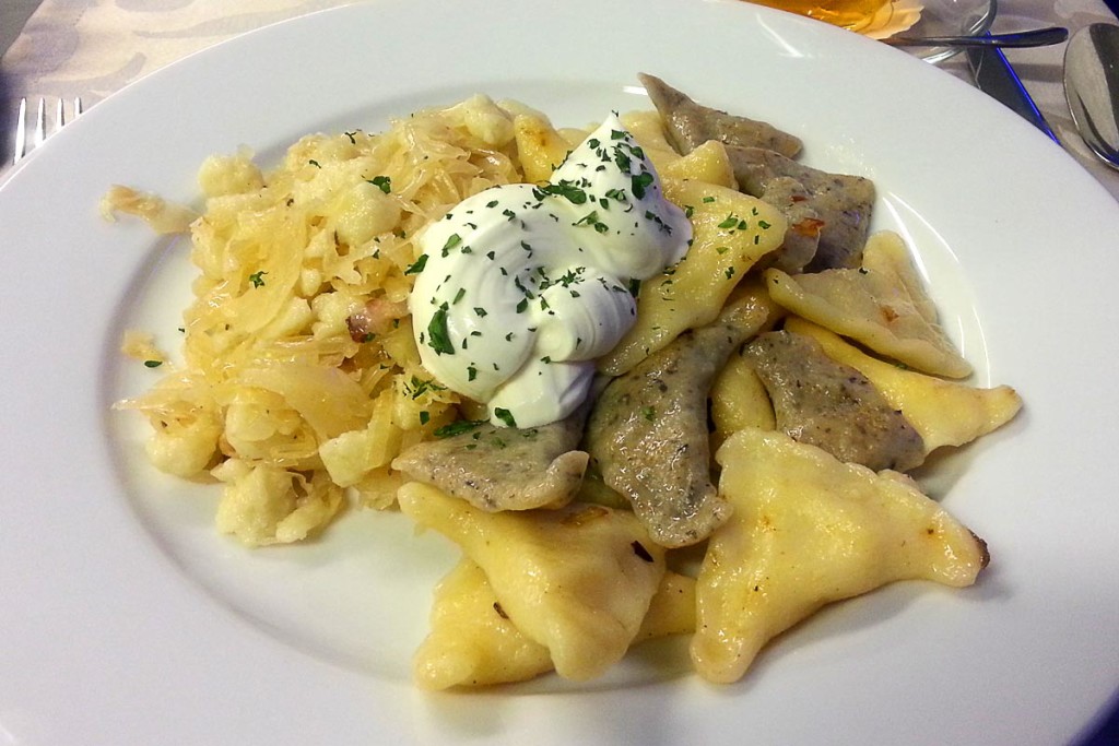 Dumplings with potatoes, sauerkraut, cheese and butter sauce.