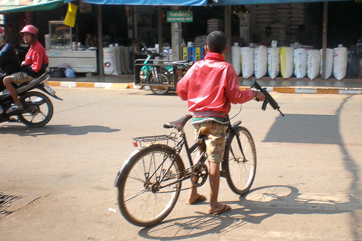 boy-with-toy-gun-street-thong-pha-phum-thailand