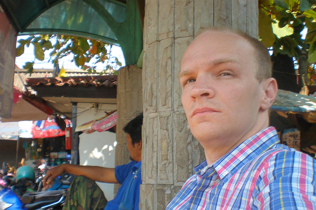 With one of my new shirts, waiting for the bus in Thong Pha Phum.