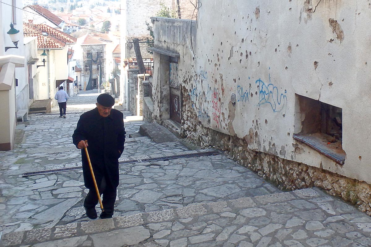 Alley in Mostar, bullet holes still in the walls.