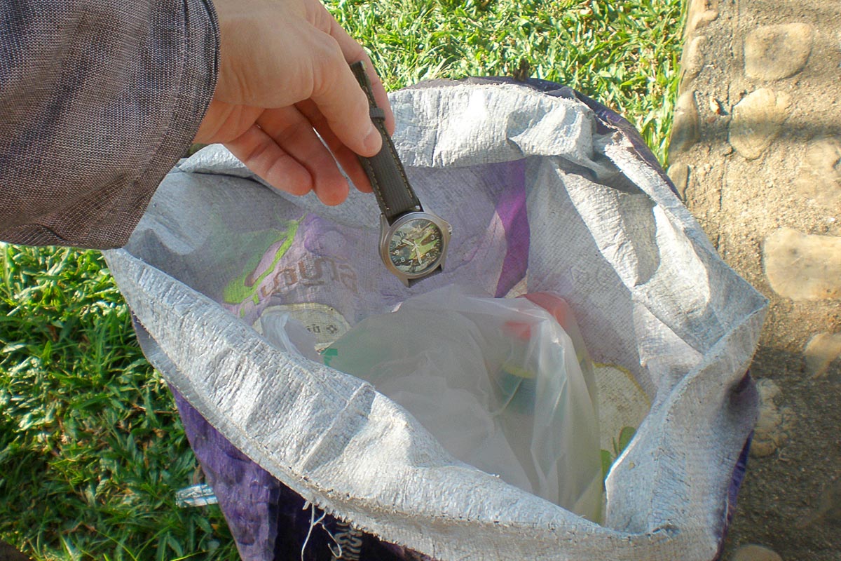 throwing-watch-in-trash-sangkhlaburi-thailand