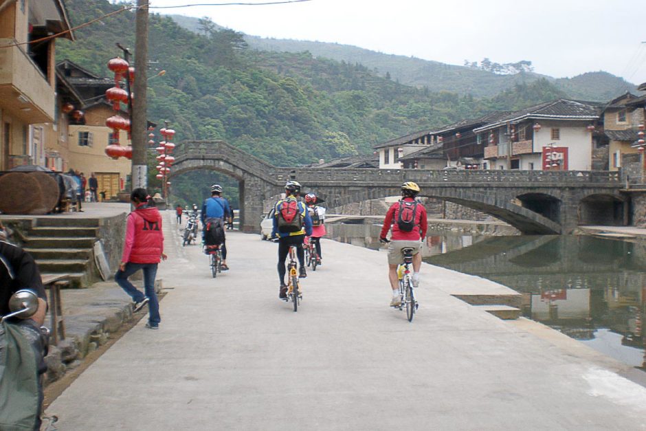 The Taiwanese triathletes ride out of Taxiacun.