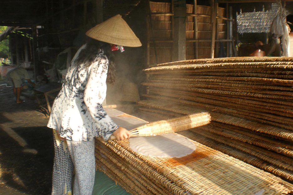 woman-conical-hat-making-rice-paper-can-tho-vietnam