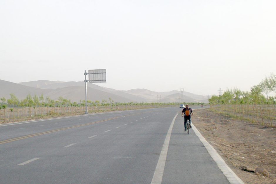 jeremy-biking-near-sand-dunes-dunhuang-china