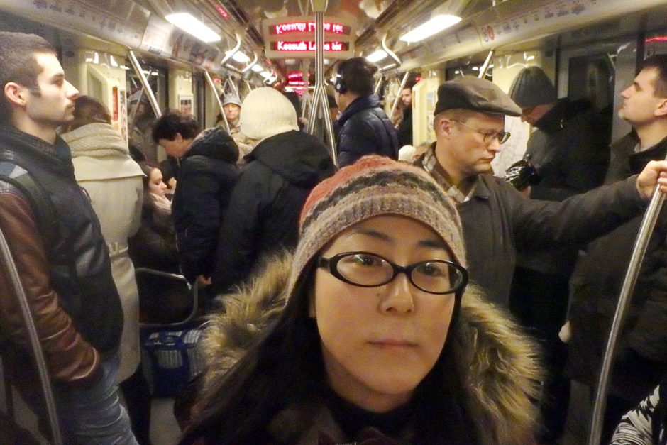 Traveling Masayo, among regular people going to work on the Budapest Metro.