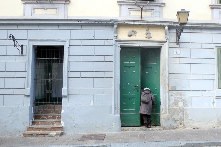 old-woman-entering-rabbit-house-ptuj-slovenia