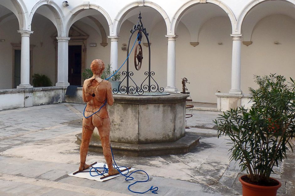 red-woman-statue-courtyard-fountain-piran